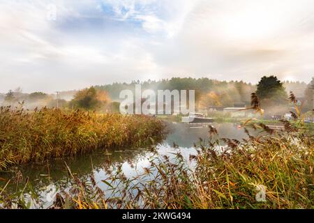 Misty autumn sunrise at Dilham canal on the River Ant in North Walsham in Norfolk Stock Photo