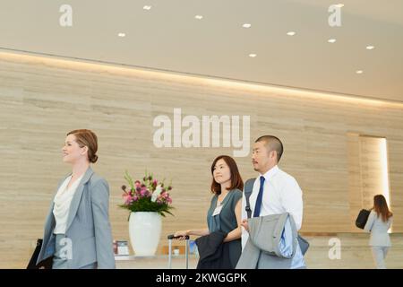 Business, corporate team in hotel and walking to international meeting, company workshop and coaching seminar. Employee trade show, management work Stock Photo