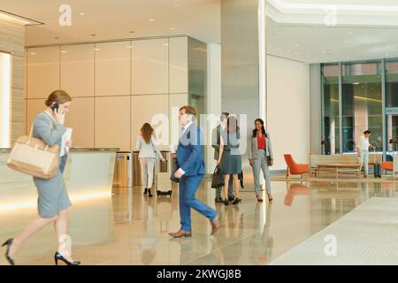 Business people, walking and an airport terminal for travel, global trade and success. Working, group and workers take steps though lobby with Stock Photo
