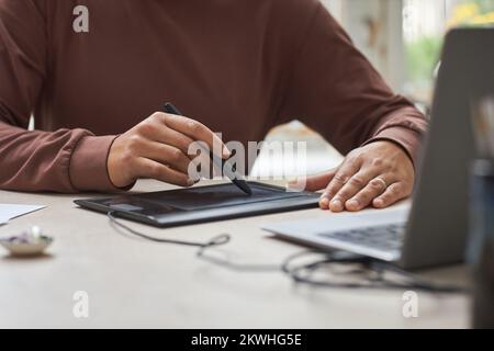 Close up of unrecognizable female artist using graphic tablet and creating new designs Stock Photo
