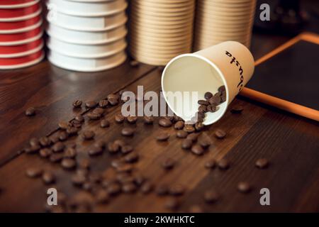 Cafe interior with roasted coffee beans on a wooden table Stock Photo