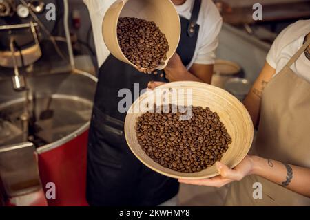 Experienced workers involved in the coffee sorting process Stock Photo