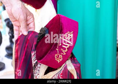 Traditional Tunisian dress for kids in the old market. Stock Photo
