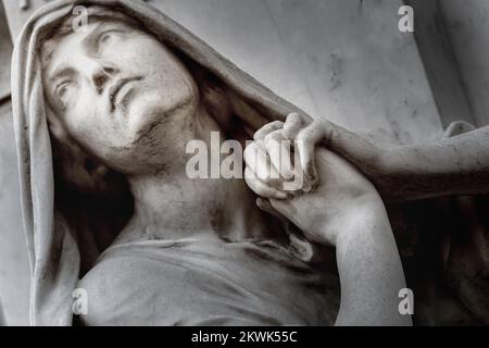 Faithfull Virgin Mary with praying hands and blessing, looking at the sky Stock Photo