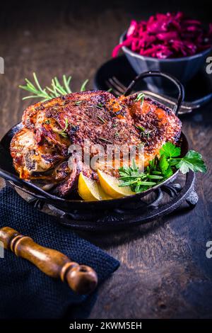 Roasted turkey knuckle with pickled red cabbage salad on wooden background Stock Photo