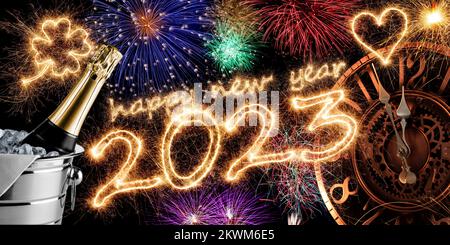 2023 sparkler number with golden clock champagne bottle in silver cooler and colorful fireworks display on black. happy new year eve dark background Stock Photo
