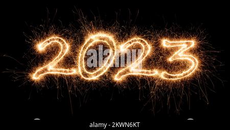 2023 sparkler golden number bright gold fireworks display on black. dark celebration happy new year eve change of the year concept background Stock Photo