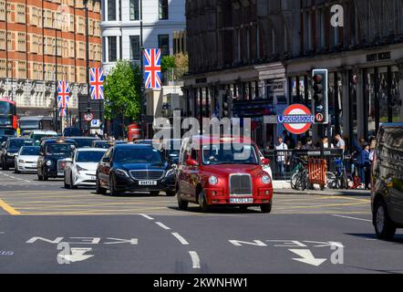 Traffic on a street in Knightsbridge, London. Stock Photo