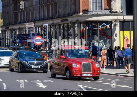 Traffic on a street in Knightsbridge, London. Stock Photo