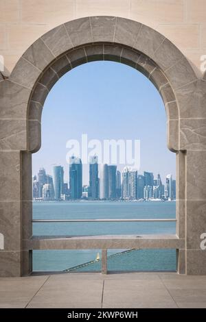 View of corniche skyline through the arcade in Doha, Qatar. Stock Photo