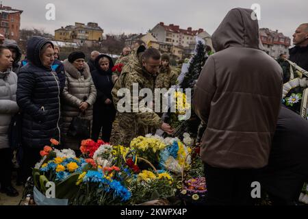 Lviv, Ukraine, Ukraine. 29th Nov, 2022. Oleg Bervetskyi, 39, was killed on November 21, 2022, in combat after a recent visit home for his birthday. His wife, Natalia, and two children said goodbye surrounded by family and friends while air alarms sounded out. He was buried alongside Maksym-Mykhailo Vrubel at Lychakiv cemetery after a service at the Garrison Church of Saints Apostles Peter and Paul in Lviv, Ukraine on November 29, 2022. (Credit Image: © Svet Jacqueline/ZUMA Press Wire) Stock Photo