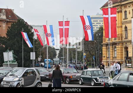 21.10.2014., Zagreb, Croatia - Croatian and Danish flags placed in front of the Croatian National Theatre before the arrival of the Danish royal couple Queen Margrethe II and Prince Henrik.  Stock Photo