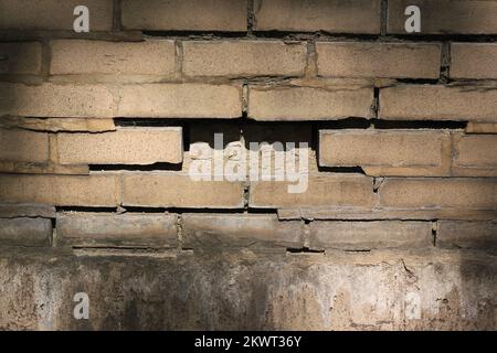 Typical common brick wall with a missing piece. Stock Photo