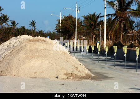Hurricane Wilma,  Key West, FL, November 4, 2005   Mounds of sand are piled up in the middle of the street by city workers, adjacent to the ocean. The sand covered the street as a result of Hurricane Wilma.. Photographs Relating to Disasters and Emergency Management Programs, Activities, and Officials Stock Photo