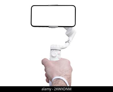 Electronic stabilizer for smartphone in human hand isolated on a white background. Hand holds 3 axis gimbal stabilizer isolated. Gimbal close up isola Stock Photo