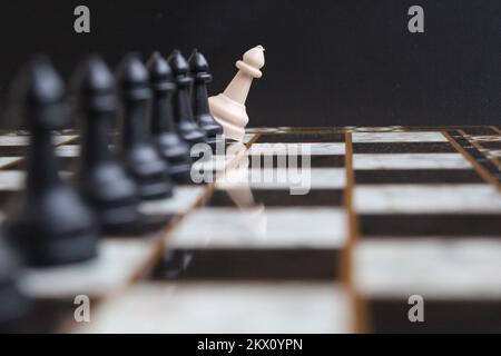 chess pawn pieces lined up in a row. black and white colored pawns. intelligence and strategy game. Stock Photo