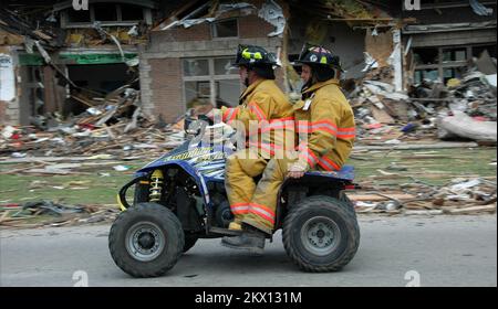 Severe Storms, Tornadoes, and Flooding,  Parkersburg, IA, May28,2008   Parkersburg firemen survey the damaged homes from an EF-5 tornado while riding on an ATV. Barry Bahler/FEMA.. Photographs Relating to Disasters and Emergency Management Programs, Activities, and Officials Stock Photo