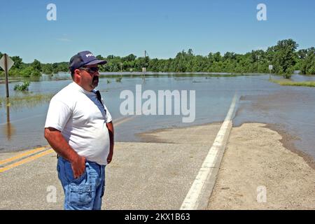 Severe Storms, Tornadoes, and Flooding,  Columbus Junction, IA, June 14, 2008   Assistant Police Chief Donnie Orr looks out over the lake that was Rt 70 just a few days ago. The deepest flood in memory threatens to get deeper tomorrow when high water from both the Iowa and Cedar rivers flow down from the north and meet right here.. Photographs Relating to Disasters and Emergency Management Programs, Activities, and Officials Stock Photo