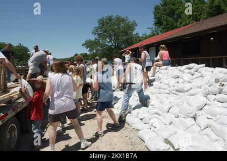 Severe Storms, Tornadoes, and Flooding,  Columbus Junction, IA, June 13, 2008   Volunteers place sandbags around Roadhouse 92, a favorite local restaurant, to protect it from predicted high water. The Cedar and Iowa rivers meet at Columbus Junction, and both are bringing high water from the heavy rains that flooded Cedar Rapids, just eighty miles north.. Photographs Relating to Disasters and Emergency Management Programs, Activities, and Officials Stock Photo