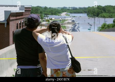 Severe Storms, Tornadoes, and Flooding,  Columbus Junction, IA, June 14, 2008   Local residents look down at the hastily built sandbag dike which is currently holding back water from the swollen Cedar and Iowa rivers, which meet in Columbus Junction. The dike could fail when high water from both rivers arrive here in a day or two.. Photographs Relating to Disasters and Emergency Management Programs, Activities, and Officials Stock Photo