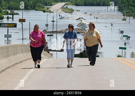 Severe Storms, Tornadoes, and Flooding,  Columbus Junction, IA, June 17, 2008   Local residents Janice Pugh, Frieda Sojka, and Cathy Crawford made the long walk up the highway 92 ramp after delivering homemade lunches to the Iowa National Guardsmen manning the roadblock to the flooded road. The ladies have earned a reputation as the best cooks in Louisa County.. Photographs Relating to Disasters and Emergency Management Programs, Activities, and Officials Stock Photo