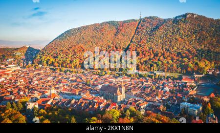Brasov, Romania - Aerial drone view of historical downtown, Council Square, Wthite Tower and Black Church, autumn landscape in Transylvania. Stock Photo
