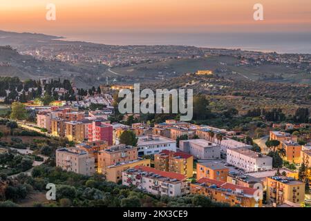 Agrigento, Sicily, Italy cityscape towards the Valley of the Temples and the Mediterrean at dawn. Stock Photo