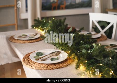Decorated Christmas plate. Served Christmas table closeup. Holiday dinner preparation Stock Photo
