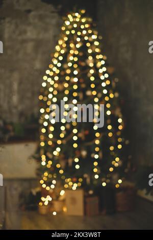 Defocused Christmas tree. blurred view. Bokeh image of Christmas tree Stock Photo