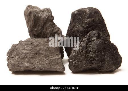 Coke (on the left) is a grey, hard, and porous coal-based fuel with a high carbon content and few impurities, made by heating coal (on the right) or o Stock Photo