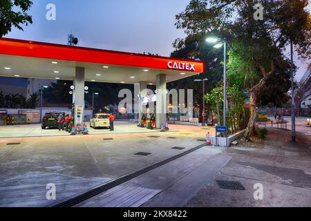 HONG KONG - FEBRUARY 04, 2015: Caltex fuel station at evening. Caltex is a petroleum brand name of Chevron Corporation used in more than 60 countries Stock Photo