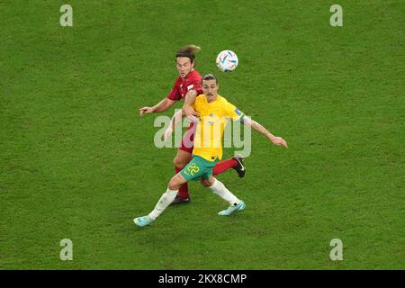 Denmark's Joachim Andersen (left) and Australia's Jackson Irvine battle for the ball during the FIFA World Cup Group D match at the Al Janoub Stadium in Al Wakrah, Qatar. Picture date: Wednesday November 30, 2022. Stock Photo