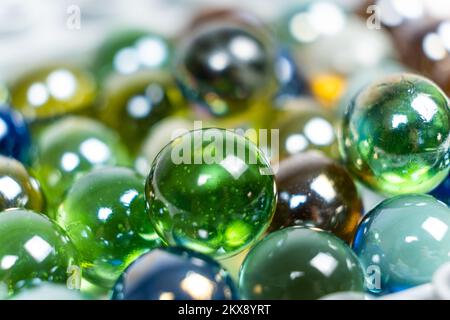 Lots of green glass beads, close-up balls. Stock Photo