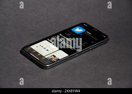 a close up of a cell phone displaying the twitter app on the app store Stock Photo