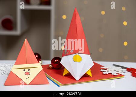 Santa Claus and the Gnome - Christmas and New Year Origami, Paper Crafts, Do It Yourself Stock Photo