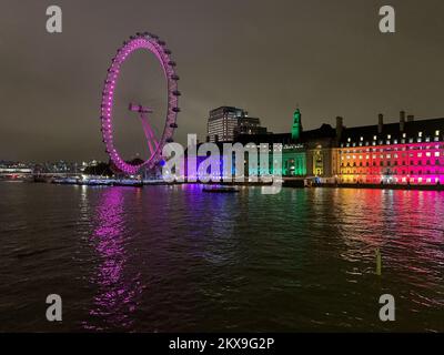 Westminster, London, UK. 29th November, 2022. Colourful lights on Westminster Bridge and the London Eye reflect onto the River Thames. Credit: Maureen McLean/Alamy Stock Photo