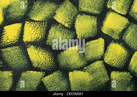 Seamless pattern with yellow paint on green leather texture, soft focus close up Stock Photo