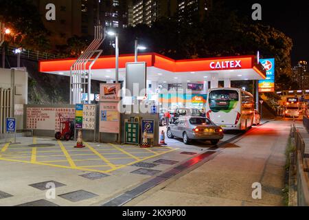 HONG KONG - APRIL 15, 2015: Caltex fuel station at evening. Caltex is a petroleum brand name of Chevron Corporation used in more than 60 countries in Stock Photo