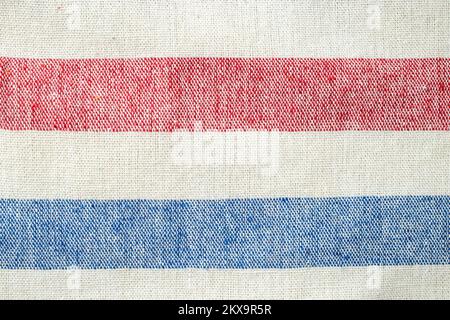Horizontal lines, red, white and blue. Thick fabric canvas, soft focus close up Stock Photo
