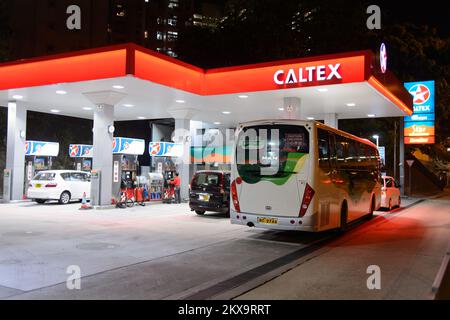 HONG KONG - APRIL 15, 2015: Caltex fuel station at evening. Caltex is a petroleum brand name of Chevron Corporation used in more than 60 countries in Stock Photo