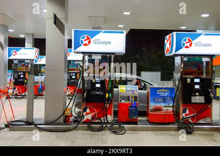 HONG KONG - APRIL 15, 2015: Caltex fuel station at evening. Caltex is a petroleum brand name of Chevron Corporation used in more than 60 countries in Stock Photo