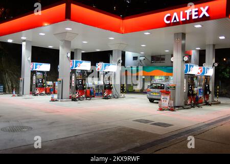 HONG KONG - APRIL 15, 2015: Caltex fuel station at evening. Caltex is a petroleum brand name of Chevron Corporation used in more than 60 countries in Stock Photo