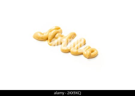 Honey mustard sauce. Splashes and spilled salad dressing isolated on white background. Soft focus close up Stock Photo