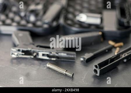 close up shallow DOF indoor shot of disassembled gun for cleaning Stock Photo
