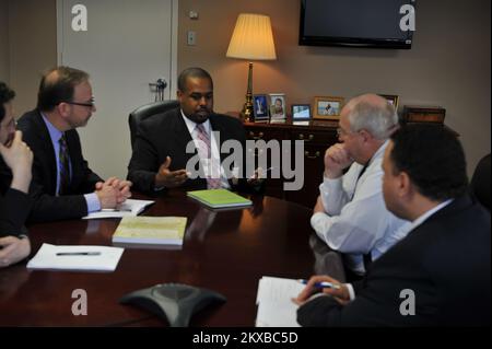 D. C. , January 18, 2011   Special Assistant to the President and Executive Director of the White House Office of Faith-based and Neighborhood Partnerships, Joshua DuBois (gesturing), meets with FEMA Administrator Craig Fugate for a discussion on the White House's and FEMA's faith-based and neighborhood partnership initiatives and how they play an integral role in FEMA's mission. Also in the meeting are Alex Amparo (right), senior advisor to Administrator Fugate, and Director of the DHS Center for Faith-based and Neighborhood Partnerships, David Myers (left). DHS/ Terry Monrad.. Photographs Re Stock Photo