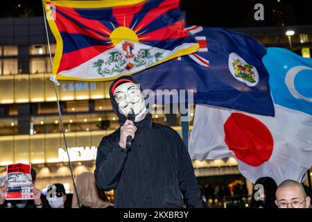 Tokyo, Japan. 30th Nov, 2022. Protesters with Guy Fawkes masks from ''Anonymous'' and V for Vendetta fame. Tokyoites, Hong Kongers, Taiwanese, Uyghurs and Chinese dissidents protest outside Shinjuku Station against President Xi Jinping and the governing Chinese Communist Party's (CCP) draconian Zero-COVID policy. (Credit Image: © Taidgh Barron/ZUMA Press Wire) Stock Photo