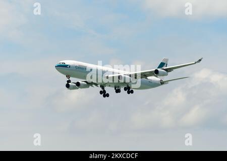 HONG KONG - JUNE 04, 2015: Cathay Pacific aircraft landing. Cathay Pacific is the flag carrier airline of Hong Kong, with its head office and main hub Stock Photo