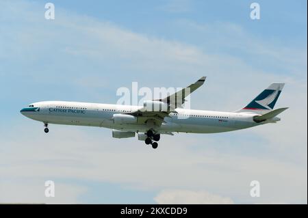 HONG KONG - JUNE 04, 2015: Cathay Pacific aircraft landing. Cathay Pacific is the flag carrier airline of Hong Kong, with its head office and main hub Stock Photo