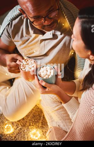Happy interracial couple celebrating New Year at home Stock Photo
