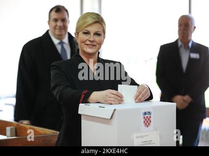 05.01.2020., Croatia, Zagreb - Croatian President Kolinda Grabar Kitarovic accompanied by her husband Jakov, voted in the second round of presidential elections. Elections for the Croatian president continued to a second round or runoff, because none of the 11 candidates received the required majority in the first election, which was held on Sunday December 22, 2019. The candidate who receives the highest number of votes in this round will win the election. Croatians choose between current president Kolinda Grabar-Kitarovic the candidate for the ruling conservative Croatian Democratic Union ( Stock Photo